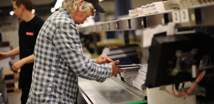 a man who works at a printing company